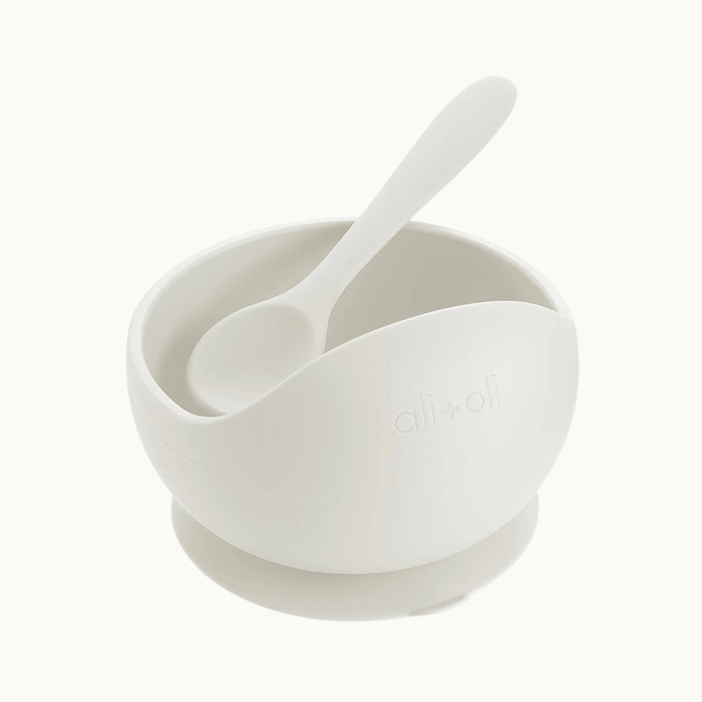 White silicone suction bowl with a spoon designed for easy feeding