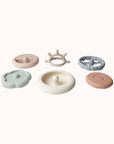 A collection of Ali + Oli Soft Silicone Stacking Rings in various colors displayed on a white background