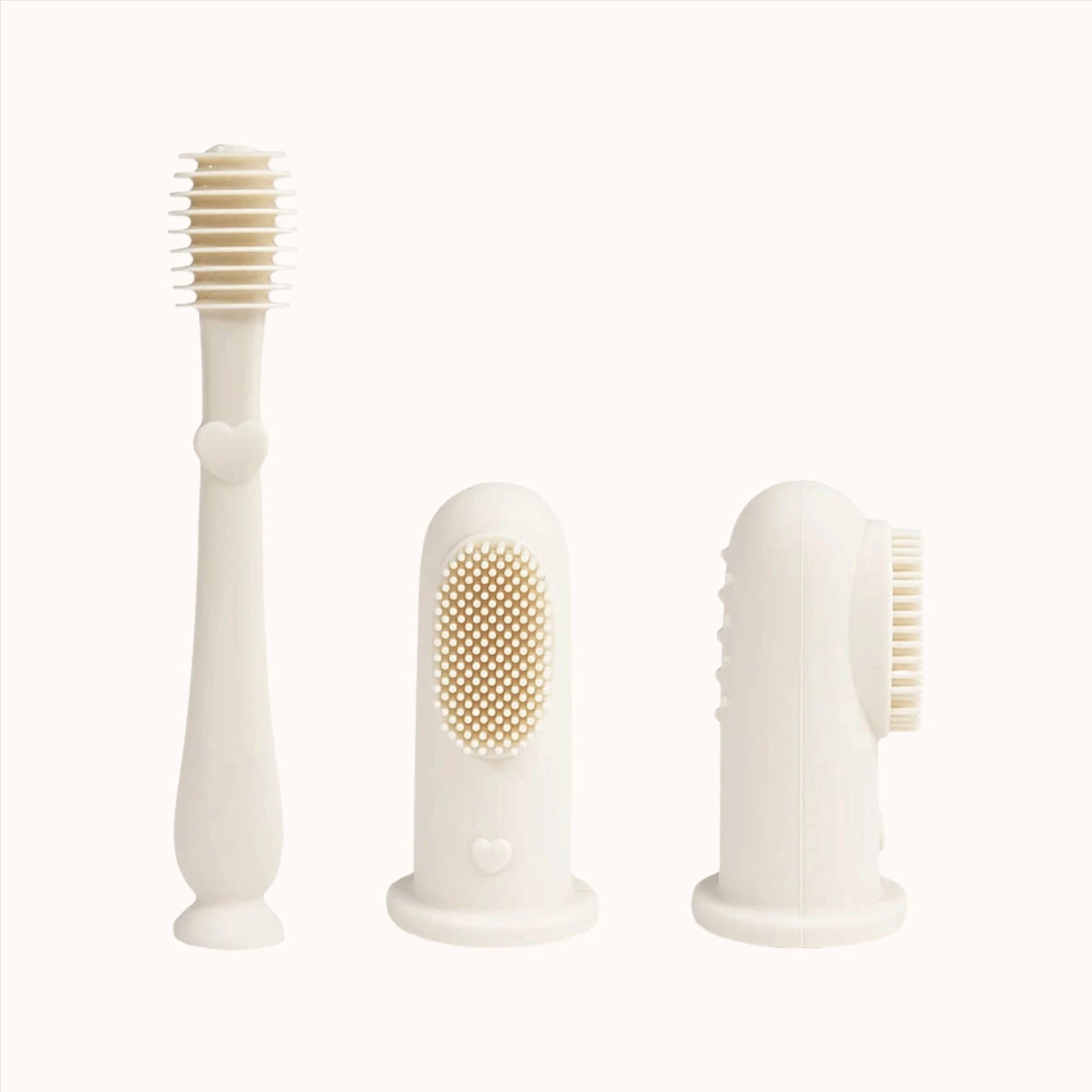 Ivory-colored Ali+Oli Baby Finger Toothbrushes presented on a clean surface