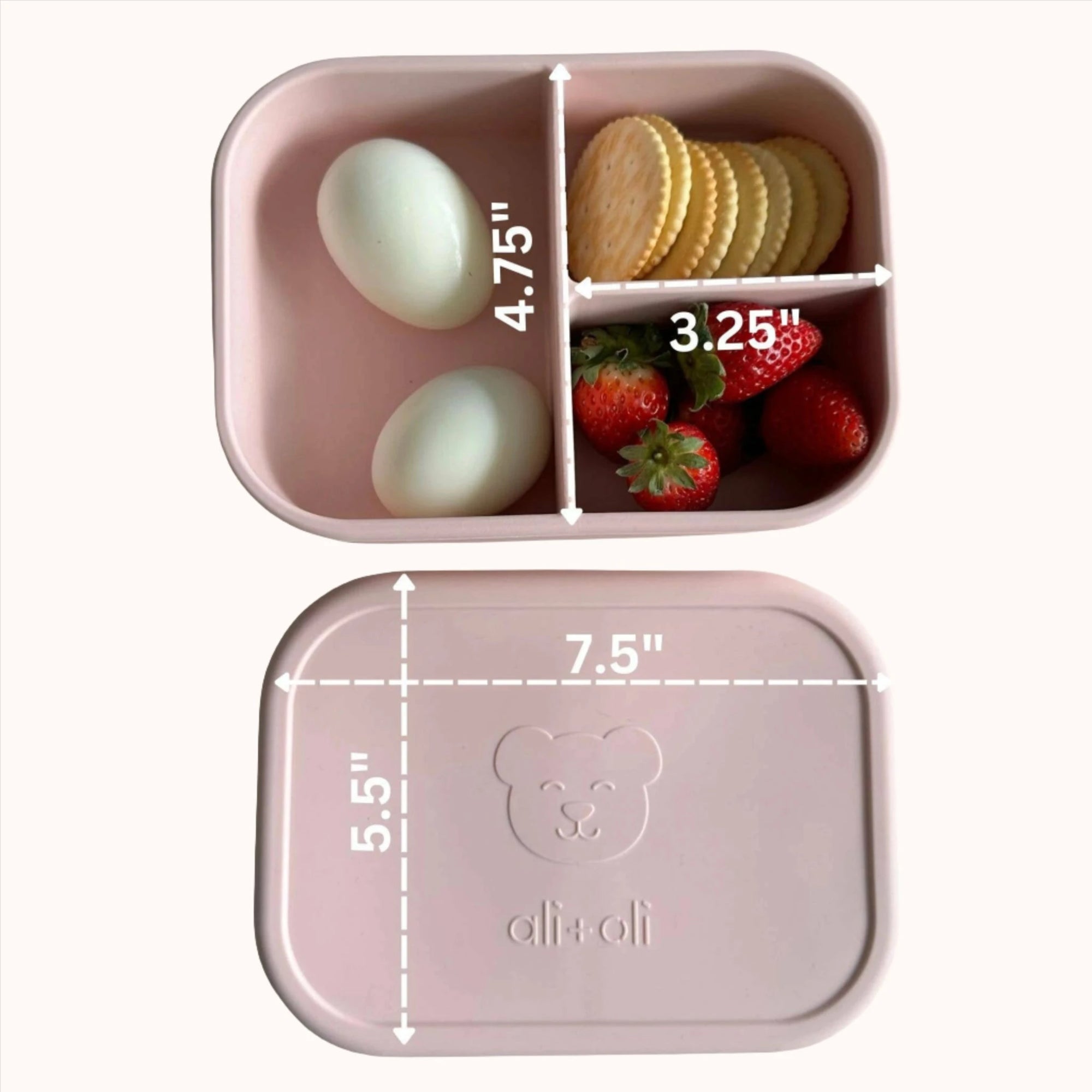 Silicone bento box in blush filled with strawberries and eggs for a healthy meal