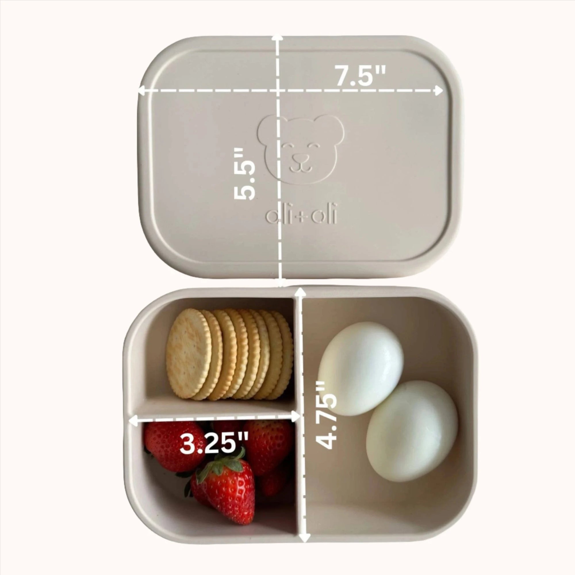 Ali+Oli Coco bento container with a mix of strawberries, cookies, and a heart-shaped treat