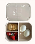 Ali+Oli Coco bento container with a mix of strawberries, cookies, and a heart-shaped treat