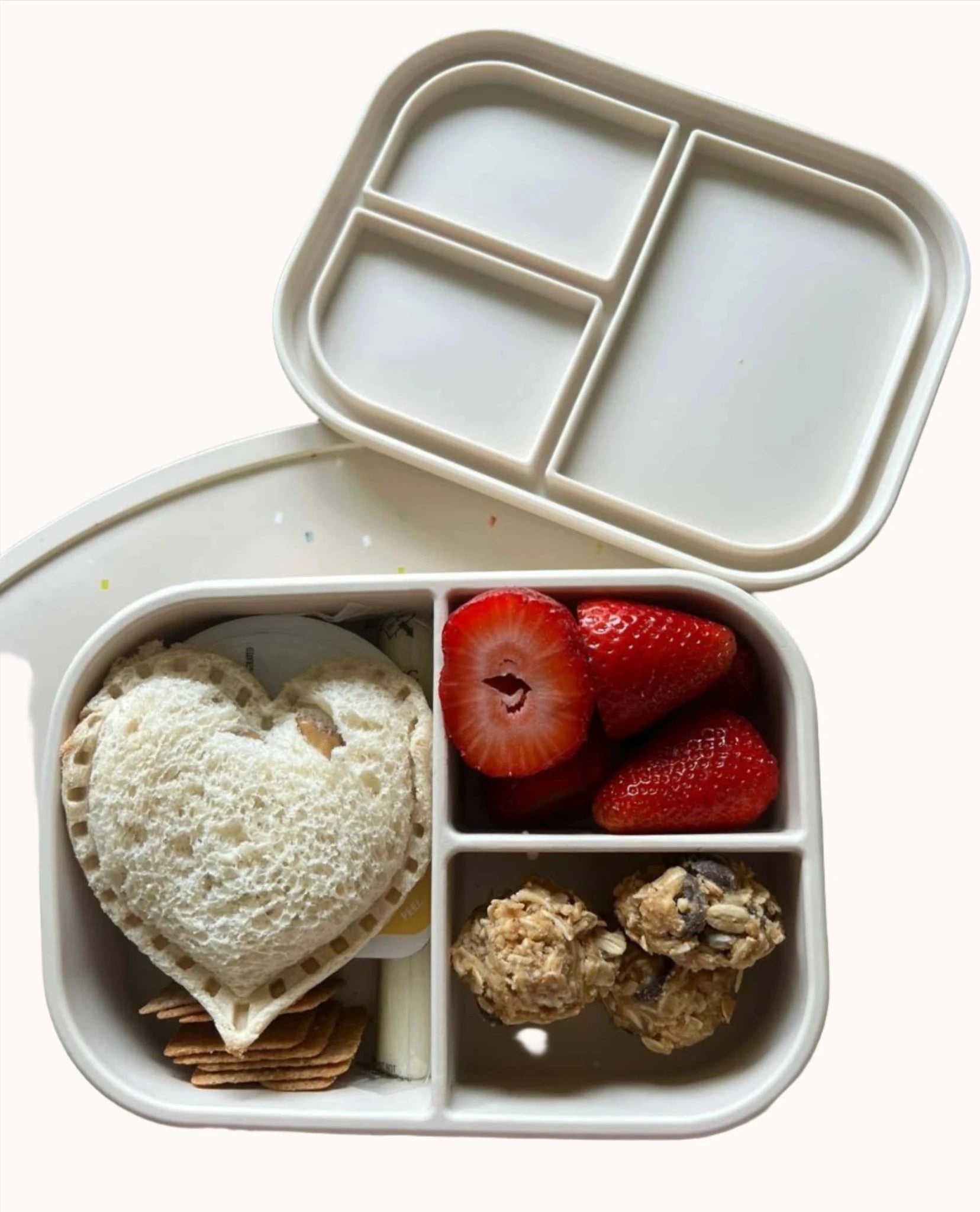 Ali+Oli silicone bento box with a sweet treat arrangement including strawberries and cookies