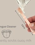 Adult hand demonstrating how to apply toothpaste on a baby finger toothbrush