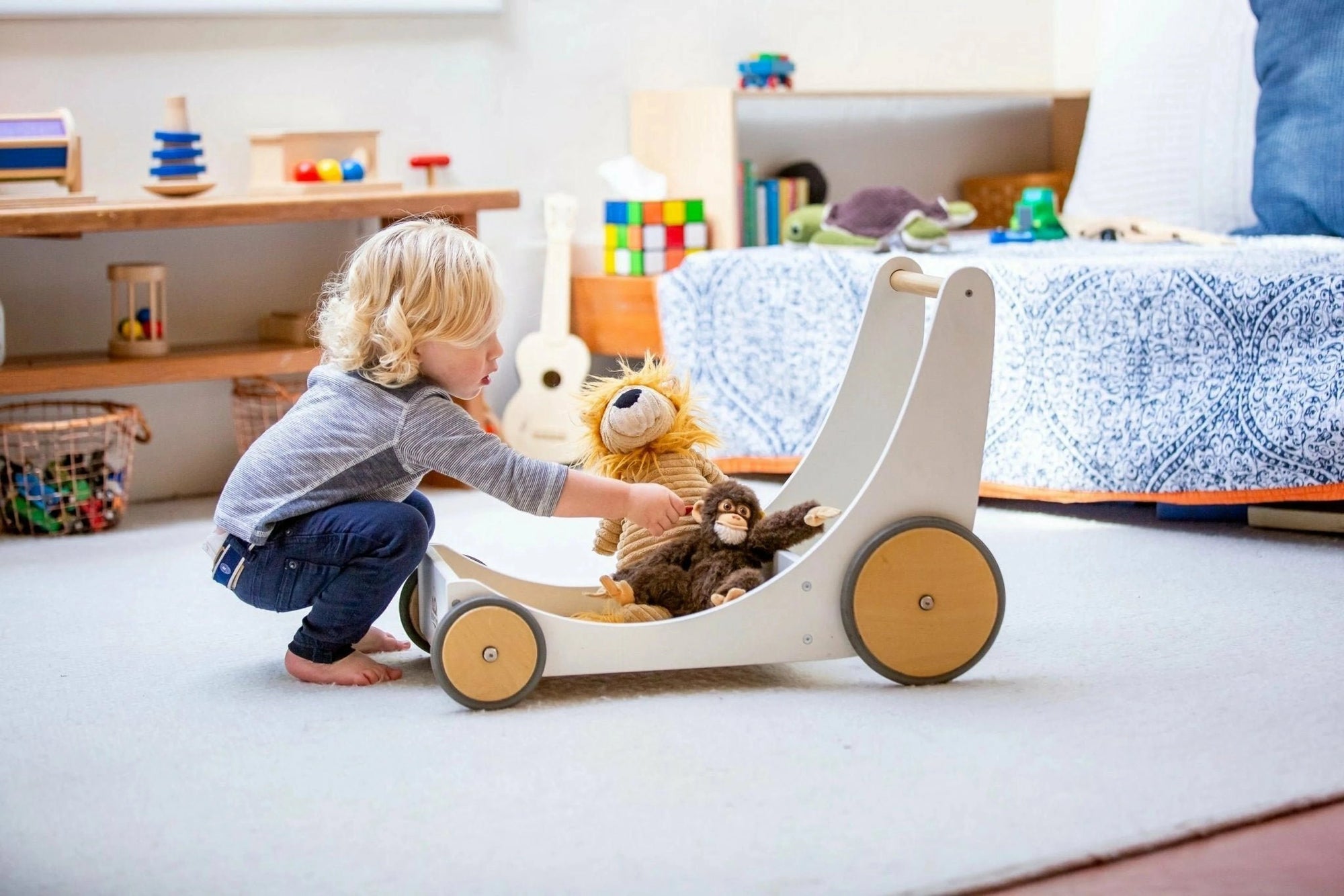 Child engaging with a white Kinderfeets Cargo Walker in a nursery