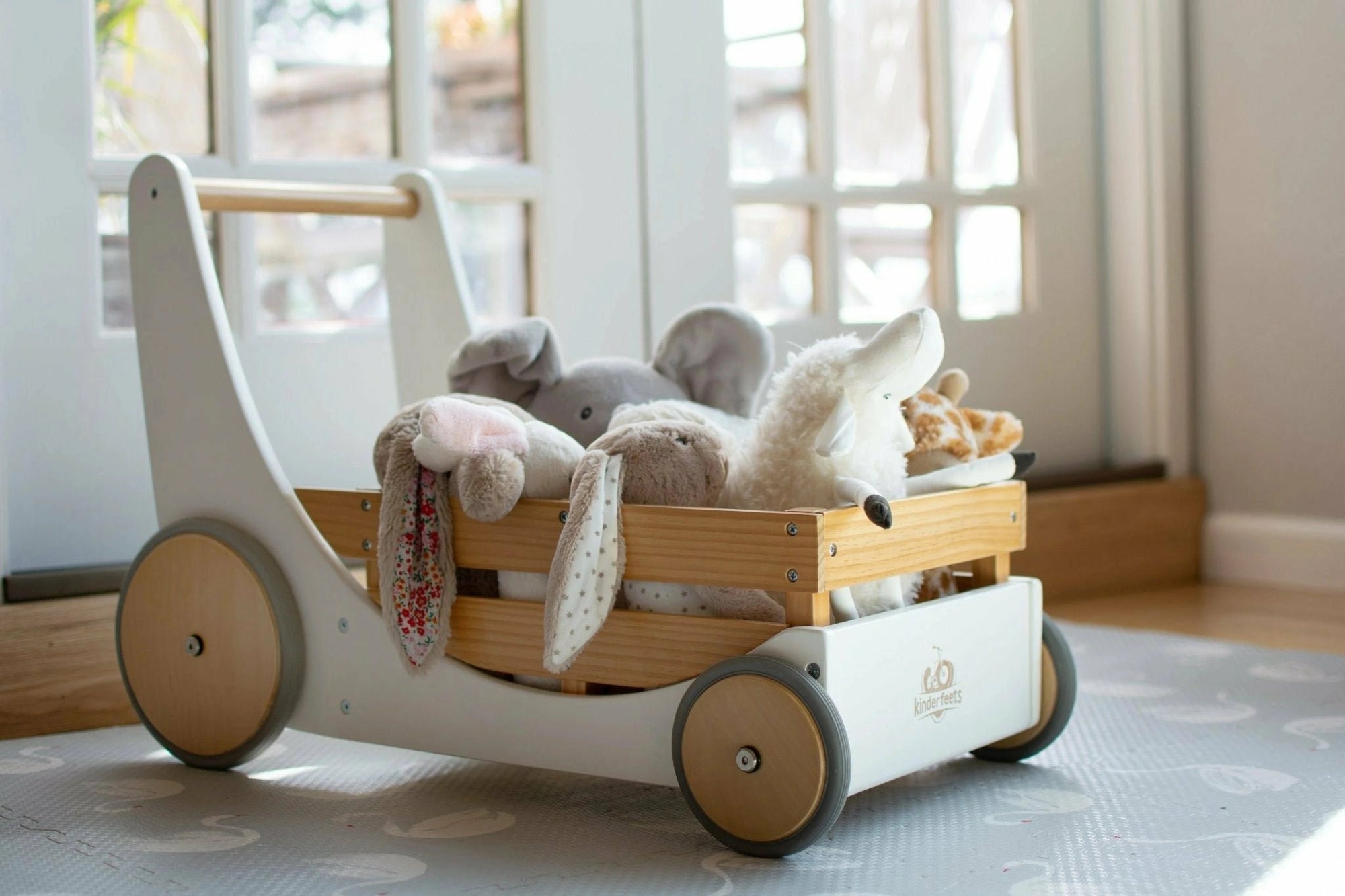 White Kinderfeets Cargo Walker filled with plush toys