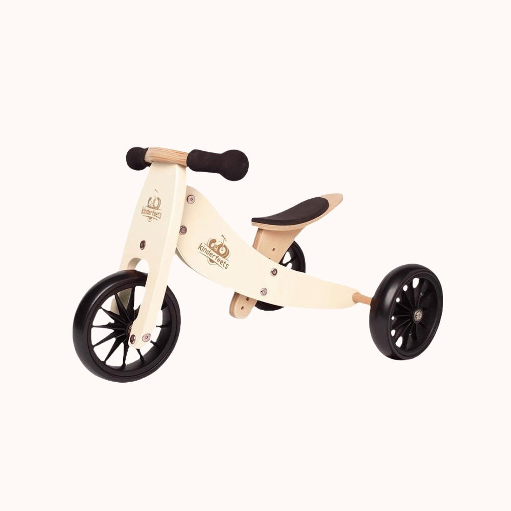 Cream-colored Kinderfeets Tiny Tot 2-in-1 balance bike and tricycle with black wheels