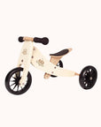 Cream-colored Kinderfeets Tiny Tot 2-in-1 balance bike and tricycle with black wheels