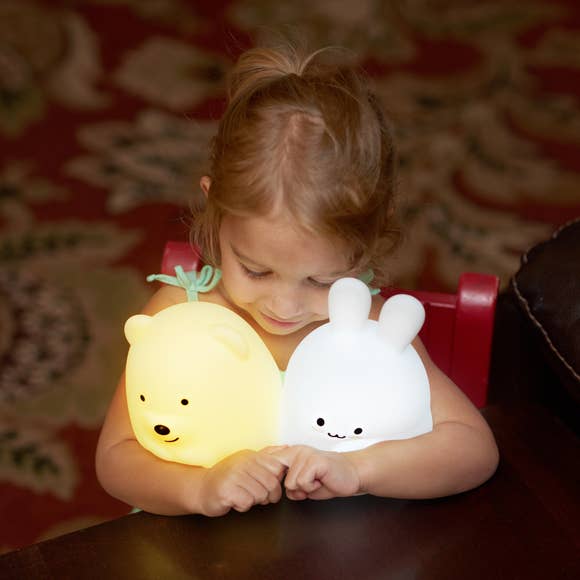 A child cuddling with a Lumipets LED bear night light