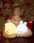 A child cuddling with a Lumipets LED bear night light