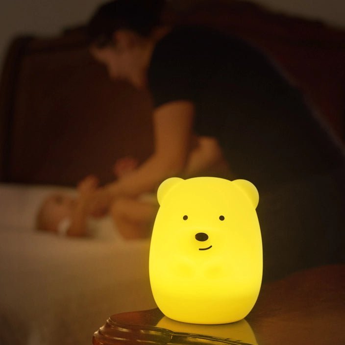 A mother and baby with the Lumipets LED bear night light illuminating softly