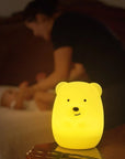 A mother and baby with the Lumipets LED bear night light illuminating softly