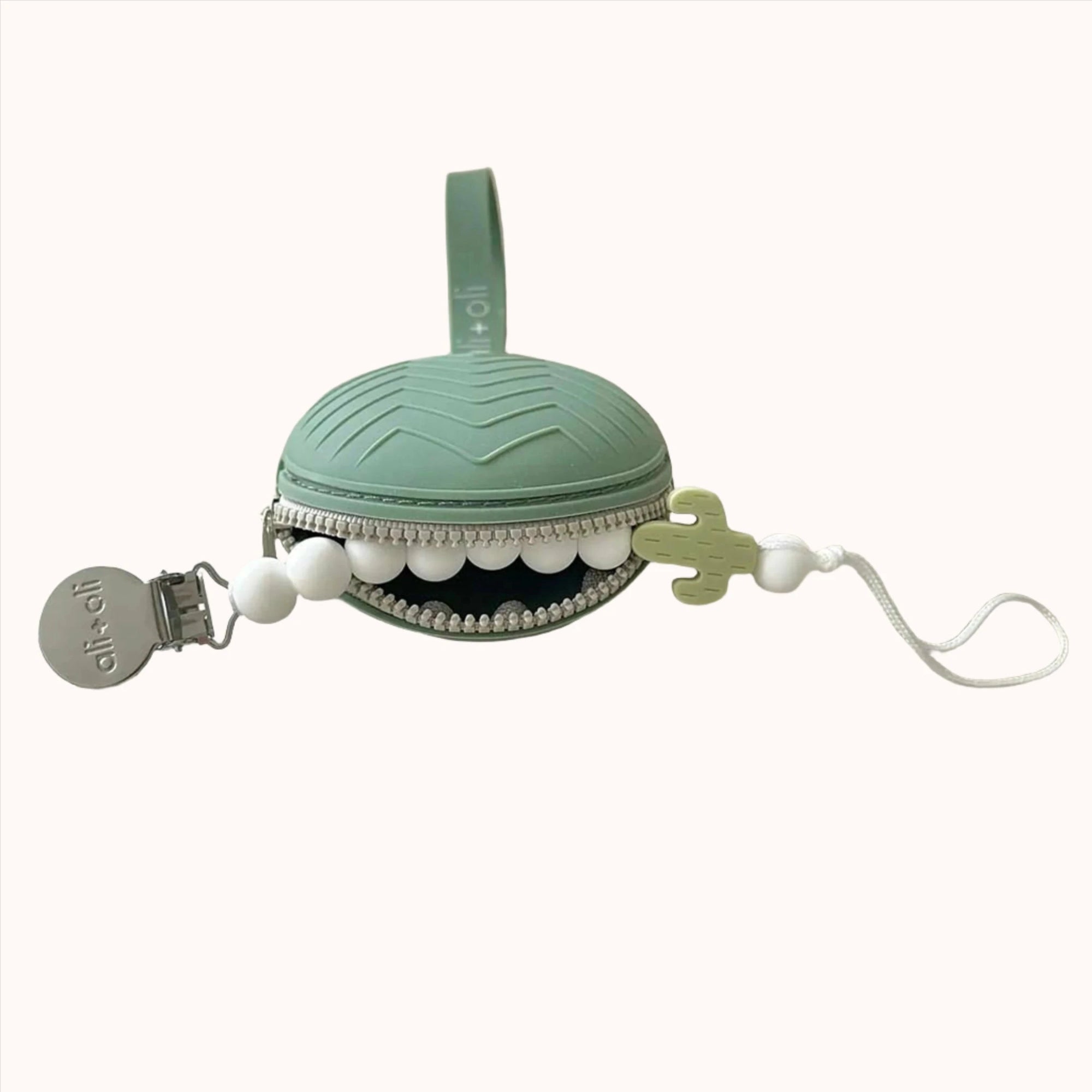 Green pacifier case adorned with a cute tooth design and zipper