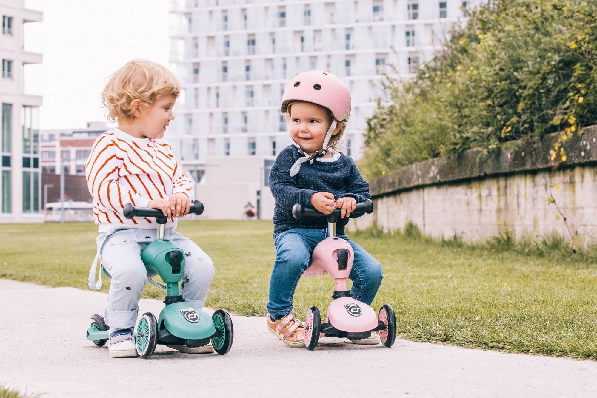 Child enjoying a ride on the rose Scoot &amp; Ride Highwaykick 1 scooter in an outdoor setting