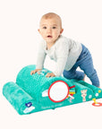 Infant engaging with Sophie La Girafe activity mat featuring a Giraffe illustration