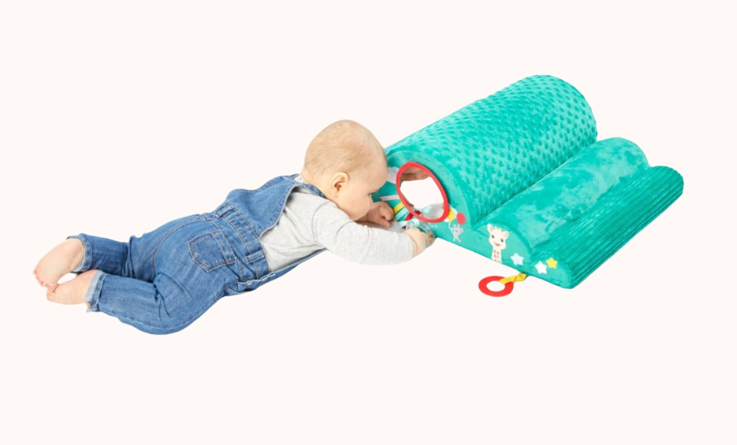 Baby on the floor interacting with a Sophie La Girafe Motor Skills Cloud toy