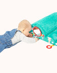 Baby on the floor interacting with a Sophie La Girafe Motor Skills Cloud toy