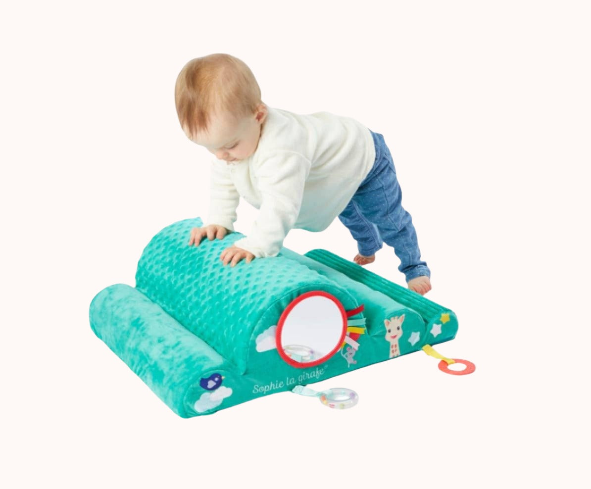 Little one climbing on a green Sophie La Girafe Motor Skills Cloud toy