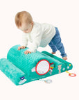 Little one climbing on a green Sophie La Girafe Motor Skills Cloud toy