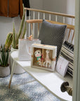 Sophie la Girafe Sophiesticated Set baby gift set with customizable card and gift bag sitting on a bench
