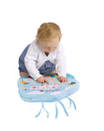 Toddler on the floor playing with Sophie la Girafe Touch & Play Board 