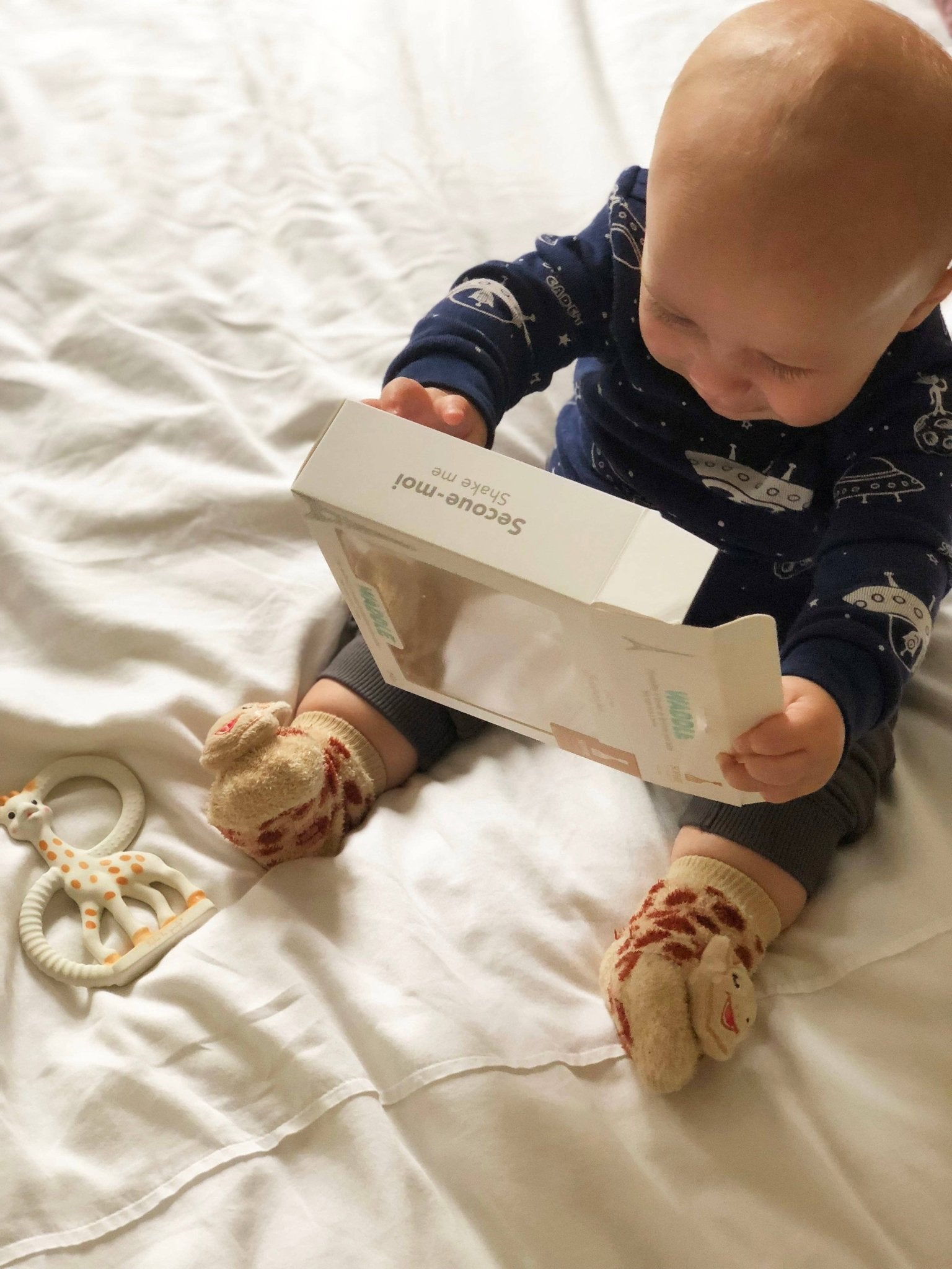 Close-up of Waddle Rattle Socks with playful animal motifs for babies