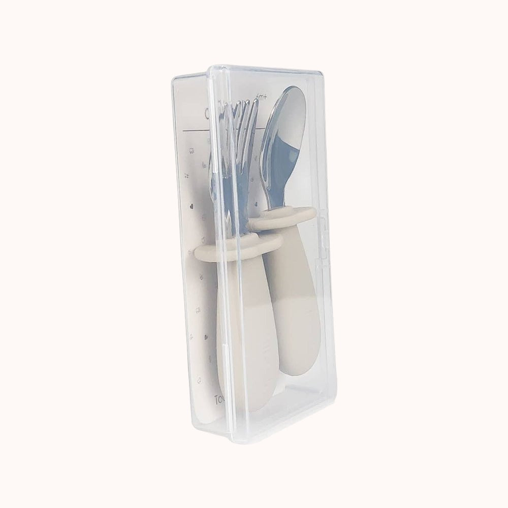 Transparent packaging showcasing Ali+Oli khaki spoon and fork set for toddlers